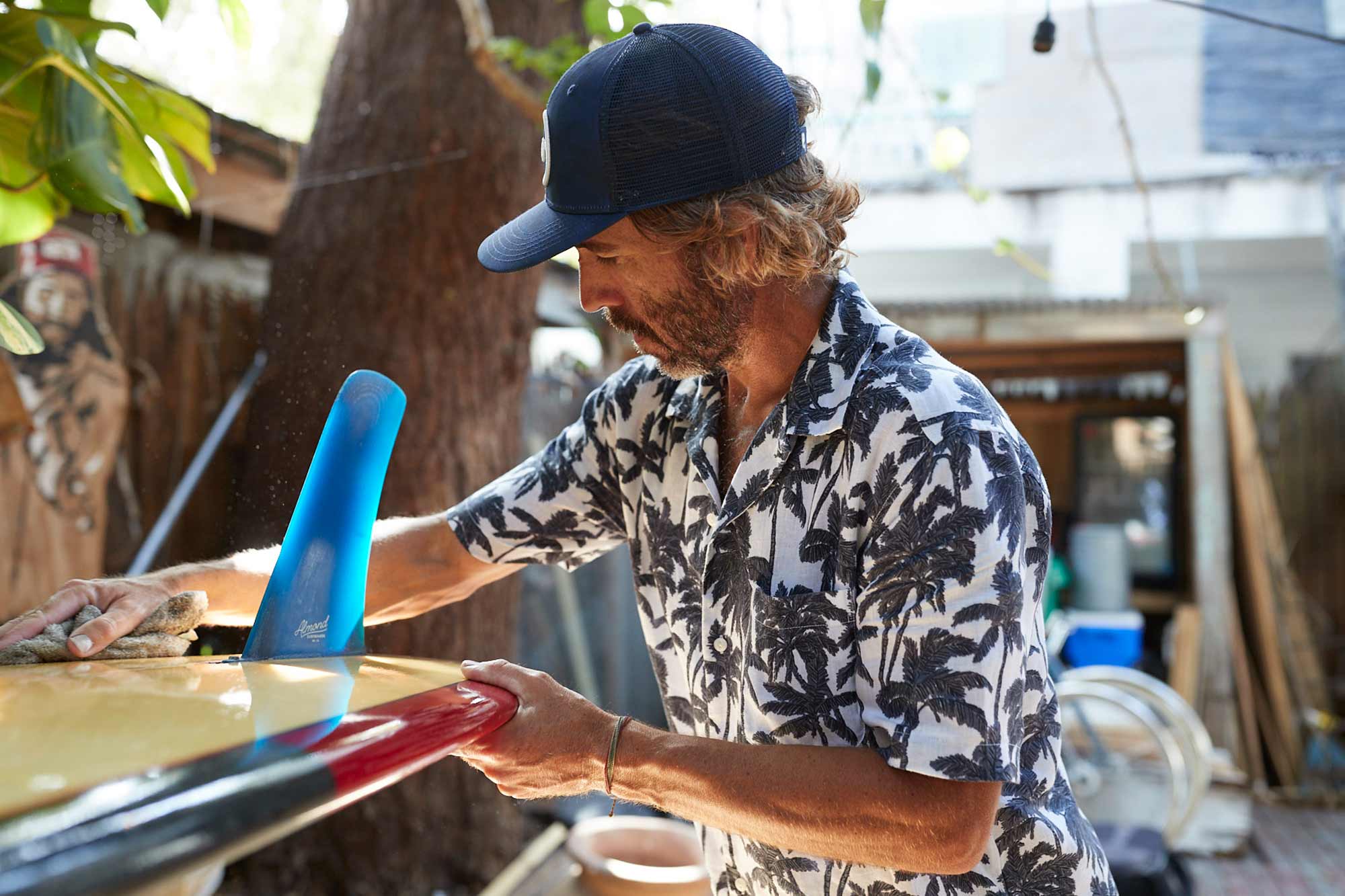 Billy Kearns wiping down a surfboard